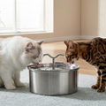 AquaPure Pro stainless steel automatic cat fountain with sculptural wave-shaped spout and two cats drinking from the flowing streams